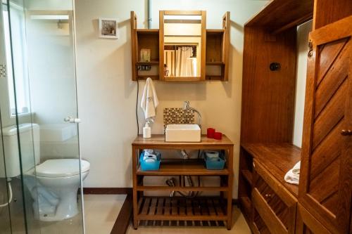 a bathroom with a shower and a toilet at Pousada Mar de Dentro in Florianópolis