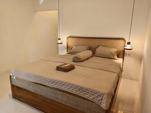 a bedroom with a bed with two pillows on it at AWAN Homestay in Kuta Lombok