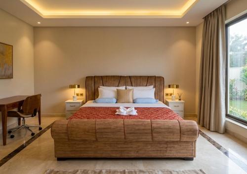 a bedroom with a large bed and a desk at Choice Lounge in Rubavu