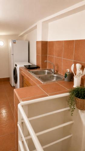 a kitchen with a sink and a refrigerator at Terrazza Rossetti in Vasto