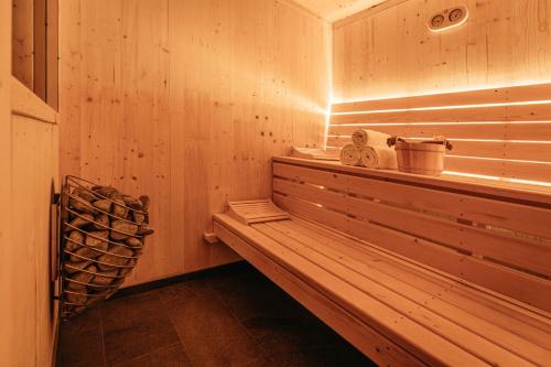 a sauna with a bench and a pile of logs at NaturResort Steinwald in Krummennaab