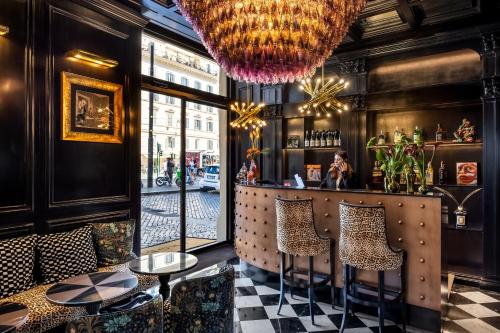 a restaurant with a bar with checkered floors at Argentum Boutique Hotel & SPA in Rome