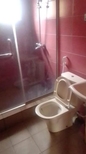 a bathroom with a toilet and a sink at October 1st Hotel in Ibadan