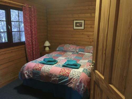 a bedroom with a bed with towels on it at Rowantree View in Roybridge