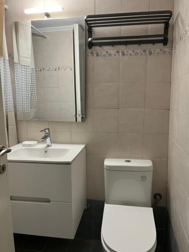 a bathroom with a white toilet and a sink at Thalassa View VB2 in Khalkoútsion