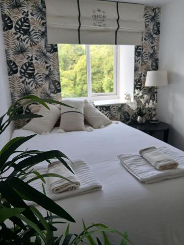 a bedroom with a white bed with a window at Claro Mews Gem in Knaresborough