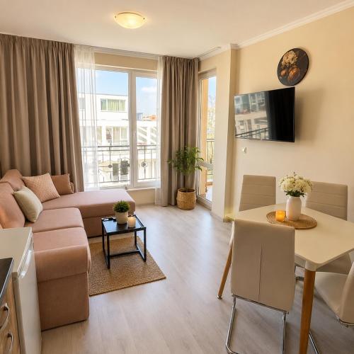 a living room with a couch and a table at Bratanov Sveti Vlas Apartments in Sveti Vlas