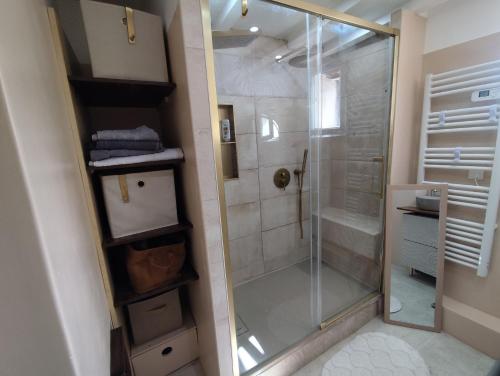 a shower with a glass door in a bathroom at Reve azur plage en duplex coeur de village in Le Pradet