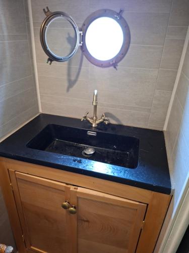 a bathroom with a sink with a mirror above it at Bateau Escapade in Ramonville-Saint-Agne