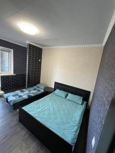 a bedroom with three beds in a room at Отель Переулок средний 16 in Kropyvnytskyi