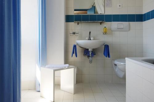 La salle de bains est pourvue d'un lavabo et de toilettes. dans l'établissement Albergo Casa Santo Stefano, à Miglieglia