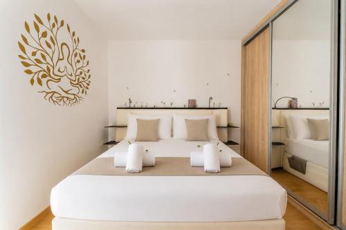 a bedroom with a large white bed with white pillows at Le Cocon Dracénois in Draguignan