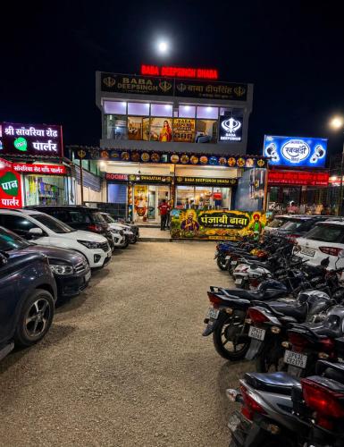 a parking lot with a bunch of parked cars at Hotel BABA DEEP SINGH RESTAURANT AND ROOMS in Ahmedabad