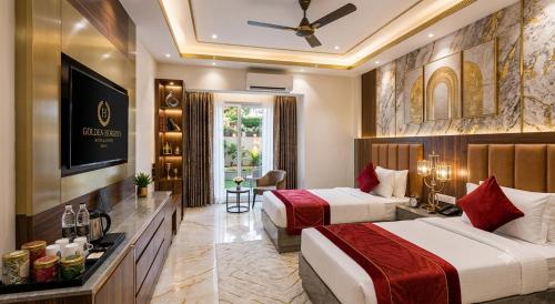 a hotel room with two beds and a television at Hotel Skynex - Near Delhi Aerocity in New Delhi