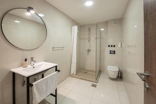 a bathroom with a sink and a shower and a mirror at Agape Rose in Tivat