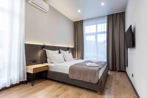 a hotel room with a bed and a window at Apartel Shayan in Shaian