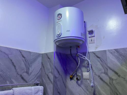 a bathroom with a blow dryer on the wall at Studio moderne in Saly Portudal