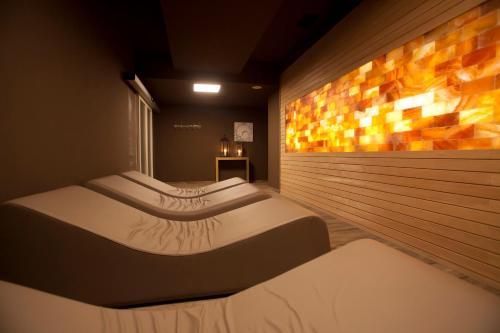 a room with three beds and a wall at Euroterme in Bagno di Romagna