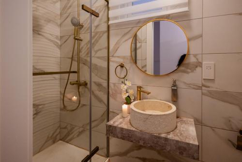 a bathroom with a sink and a mirror at St Julians`s Charm Apartments in Is-Swieqi