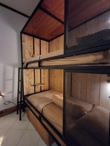 a room with two bunk beds in a room at Nglinteg Hostel in Yogyakarta