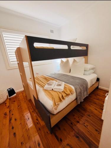 a bedroom with a bunk bed with a wooden floor at Marley's at Boma in Bomaderry
