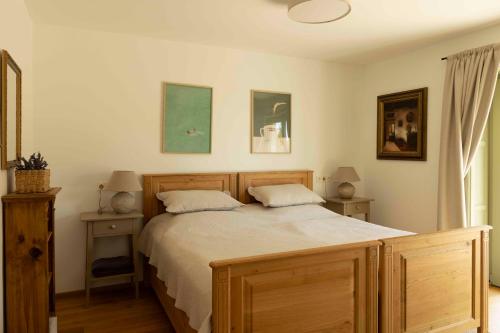 a bedroom with a large bed with two night stands at Macskalépcsős Boutique B&B in Dörgicse