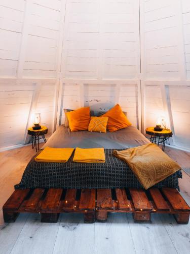 a large bed in a room with two tables at Glamping The Teepee in Mombeltrán