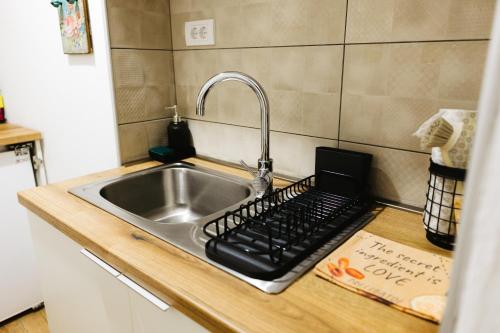 a kitchen sink with a black keyboard next to it at Apartmani Jovčić in Leskovac