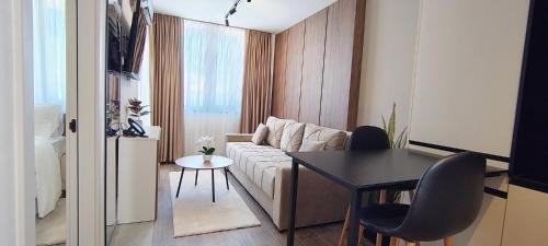 a small living room with a couch and a table at Sky Panorama in Soko Banja