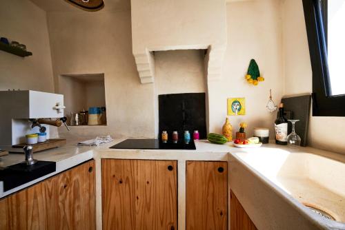 a kitchen with wooden cabinets and a sink and a tub at Trullo KAVA - Ceglie Messapica in Ceglie Messapica