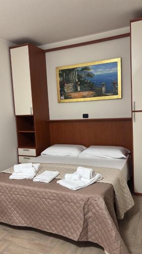 a bedroom with a bed with towels on it at B&B Dimora Elmara in San Salvo