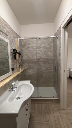 a bathroom with a shower and a sink and a glass shower at B&B Dimora Elmara in San Salvo