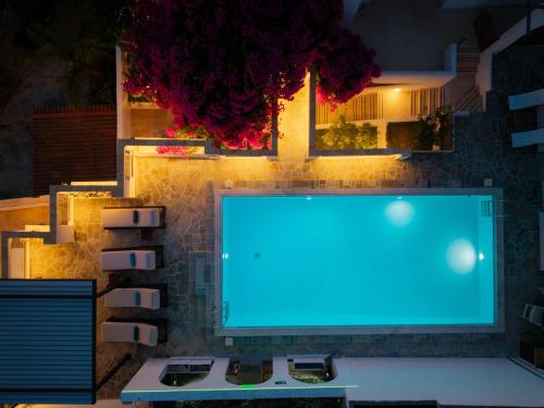 a computer monitor with a blue light on a table at ILIOS COVE by A&D Properties in Porto Rafti