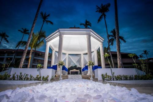 a white altar in front of a building with palm trees at Majestic Mirage Punta Cana, All Suites – All Inclusive in Punta Cana