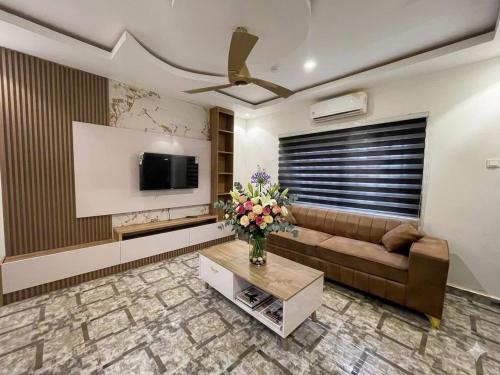 a living room with a couch and a tv at Paradise Creek Hotel in Tamale