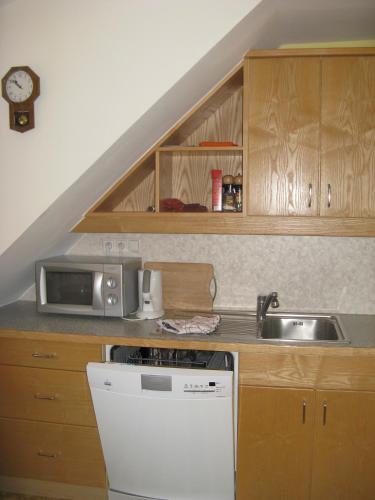 a kitchen with a sink and a microwave at Ortnerhof in Millstatt