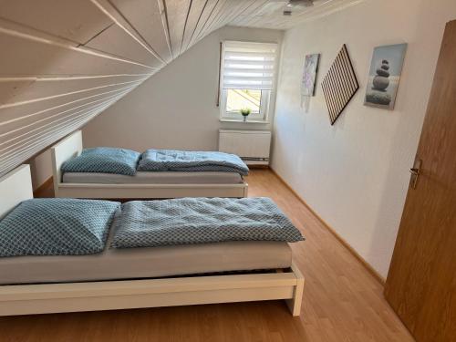 a room with three beds and a window at Casa Blanca in Schwanau