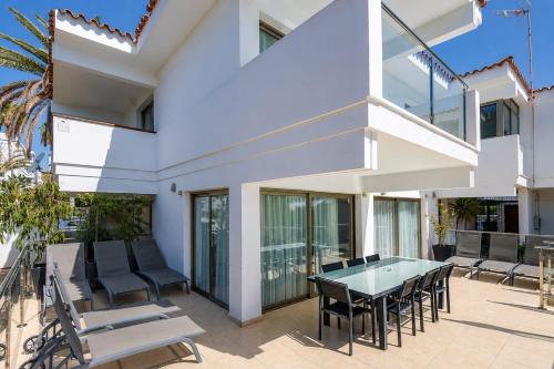 an outdoor patio with a table and chairs at GuestReady - Tarantos Sea View and Pool in Playa del Ingles