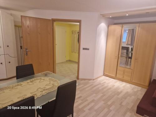 a dining room with a table and a room with a door at Justyna-Sebastian FE-WO in Paderborn