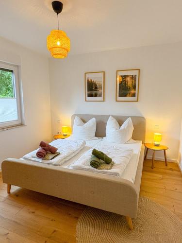 a bedroom with a bed with two pillows on it at Landhaus Holly in Frielendorf
