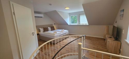 a room with a staircase with a couch and a window at White Coast Villa in Grömitz
