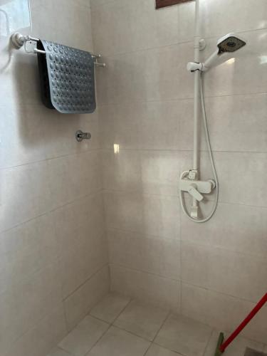 a bathroom with a shower with a shower head at Hakuna matata Apartments in Zanzibar City