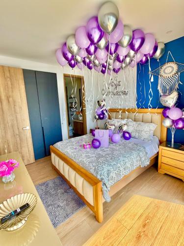 a room with a bed with purple balloons on it at Brand NEW! Ocean front,City 360Views 26FL,FREE Airport pick up by IMZ in Cartagena de Indias