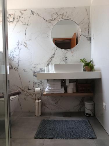 a bathroom with a sink and a mirror at Apartments Paloc - Yellow in Bol