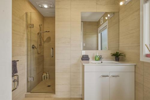 a bathroom with a shower and a sink and a mirror at Springfield bliss with Lake view in Rotorua
