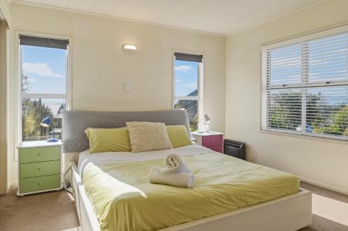 a bedroom with a bed with a towel on it at Springfield bliss with Lake view in Rotorua