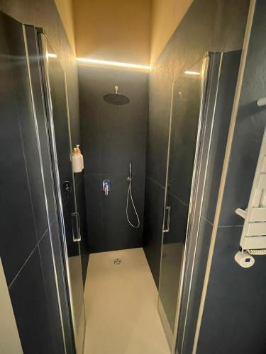 a bathroom with a shower with a glass door at Calabianca in Giglio Porto