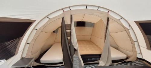 an open tent with a bed in it at De Zanglijster in Erica