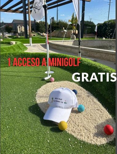 a golf course with a hat and balls on the grass at Hotel Alfonso I in Tui