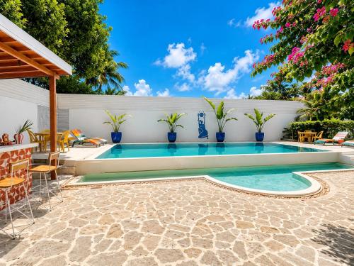 a swimming pool in a backyard with chairs and plants at Hebron Gardens House in Kandy